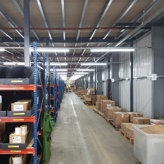 Warehouse interior with shelves and pallets of boxes and led lights