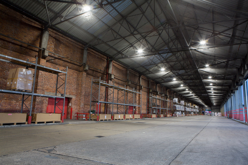 Large warehouse interior with high ceilings and metal beams.