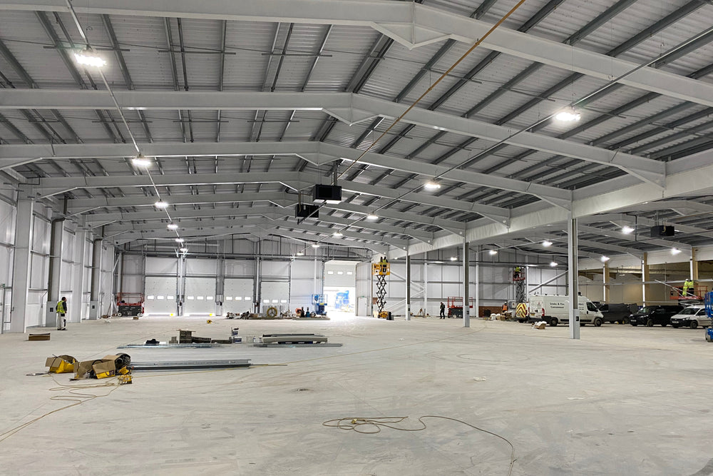 Large industrial warehouse with concrete floor and metal beams