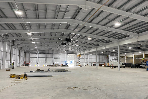 Large industrial warehouse with concrete floor and metal beams