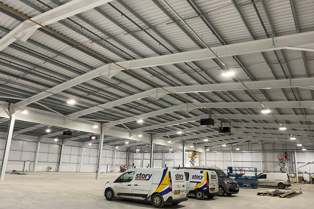 Two vans with 'Story' branding inside a large warehouse.