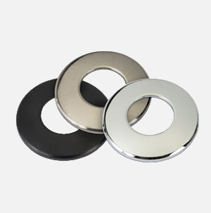 Three metal washers in black, silver, and gold on a white background