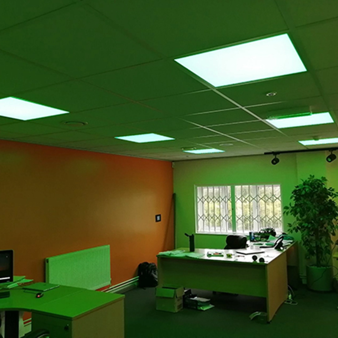 Modern office interior with green fluorescent lights on a ceiling
