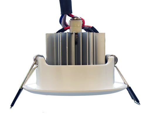 Close-up of a mechanical component with a white base and metallic parts on a white background